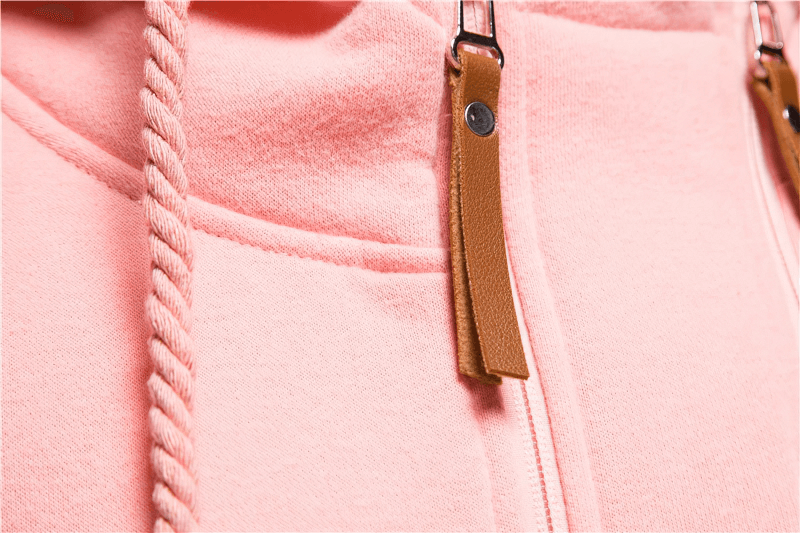 Close-up of pink two-tone hoodie with zip and rope cord detail, showcasing stylish apparel design.